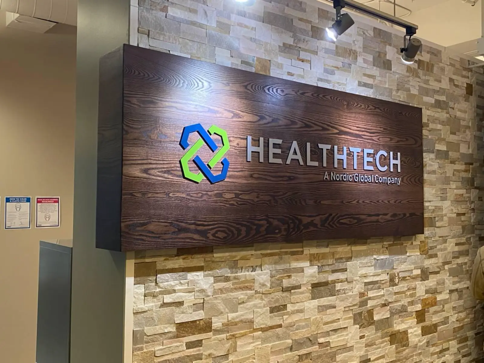 HealthTech office wall sign with modern logo installation, professional corporate branding for Nordic Global Company in Mississauga, Brampton, Toronto, Vaughan, Hamilton, Oakville, Burlington, Milton, Guelph, Kitchener, Waterloo, Cambridge, and Niagara Falls.