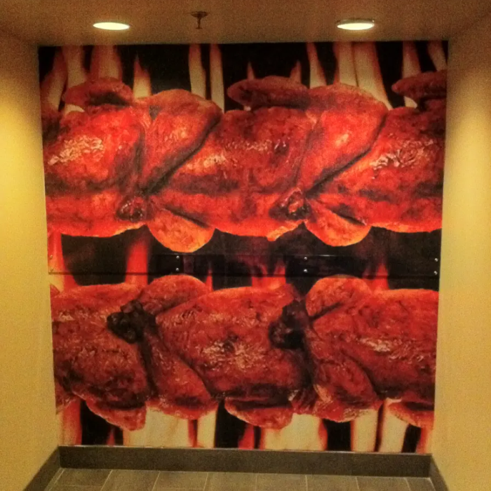 Swiss chalet Custom restaurant wall mural of grilled rotisserie chicken with promotional text printed and installed using 3M vinyl by Innovative Sign Solution, serving Toronto, Mississauga, Brampton, Vaughan, Markham, Richmond Hill, Hamilton, Burlington, Oakville, Milton, Guelph, Kitchener, Waterloo, Cambridge, London, Windsor, Niagara Falls, St. Catharines, Barrie, Oshawa, Whitby, Ajax, Pickering, and all other cities across Southern Ontario