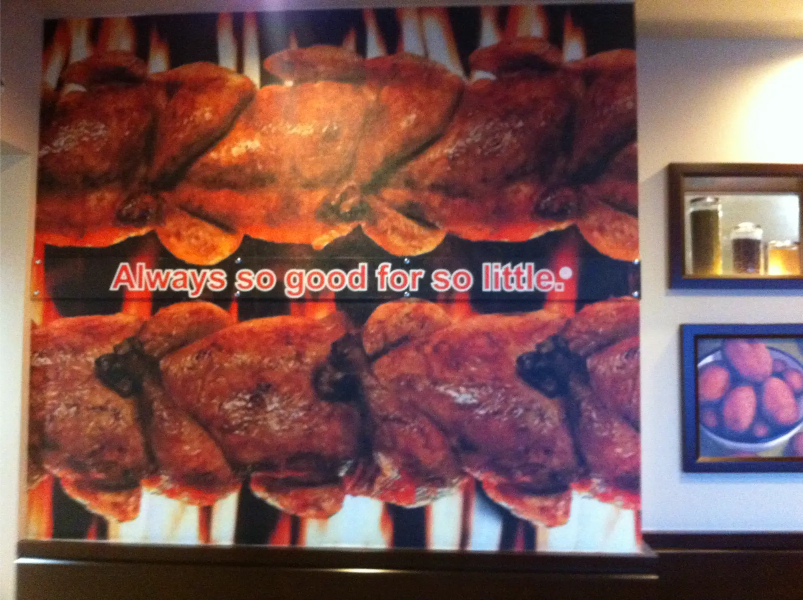 Swiss chalet Custom restaurant wall mural of grilled rotisserie chicken with promotional text printed and installed using 3M vinyl by Innovative Sign Solution, serving Toronto, Mississauga, Brampton, Vaughan, Markham, Richmond Hill, Hamilton, Burlington, Oakville, Milton, Guelph, Kitchener, Waterloo, Cambridge, London, Windsor, Niagara Falls, St. Catharines, Barrie, Oshawa, Whitby, Ajax, Pickering, and all other cities across Southern Ontario