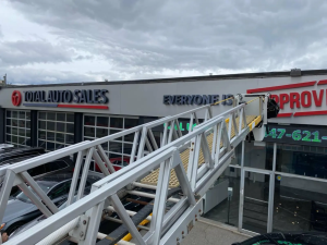 Installation of Total Auto Sales illuminated dealership sign with slogan Everyone is Approved. Professional auto dealership signage design and installation in Southern Ontario including Toronto, Mississauga, Brampton, Hamilton, London, Kitchener, Waterloo, Cambridge, Guelph, Windsor, Niagara Falls, St. Catharines, Oakville, Burlington, Milton, Vaughan, Markham, Richmond Hill, Whitby, Oshawa, Pickering, Ajax.