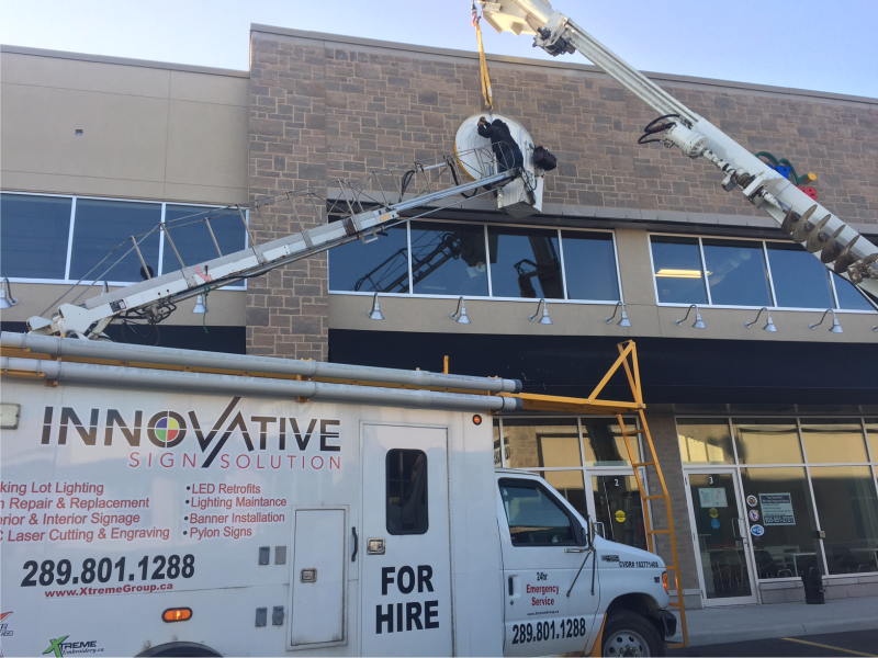 Professional Sign Installation Services | Innovative Sign Solution Innovative Sign Solution crew installing exterior business signage using a bucket truck in Southern Ontario