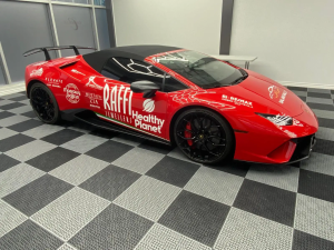 Lamborghini sports car with red sponsorship wrap designed by Innovative Sign Solution, Fleet Graphic Branding and Vehicle Wraps in Toronto, Mississauga, Brampton, Vaughan, Hamilton, Oakville, London, and Southern Ontario.